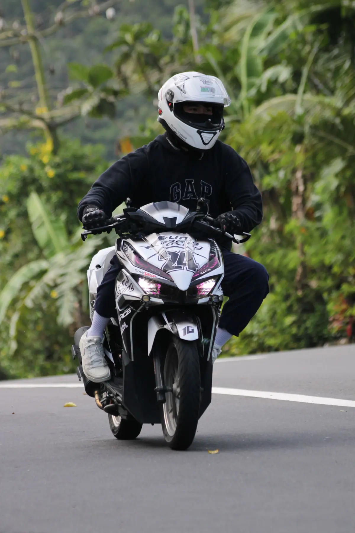 Rider on a winding tropical road
